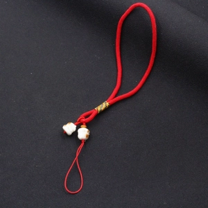 Handmade red braided phone strap with white ceramic beads for lucky charm accessory