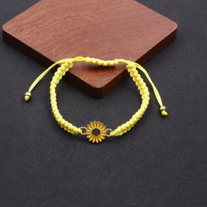Handmade woven sunflower daisy friendship bracelet with yellow enamel charm and adjustable cord