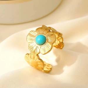 Gold stainless steel floral open ring featuring blue turquoise bead and embossed flowers