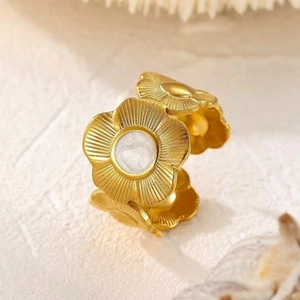 Adjustable golden flower ring with pearl inlay and radial brushed metal texture