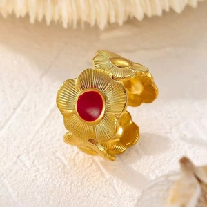 Adjustable gold stainless steel ring featuring 3D floral designs with red center stones