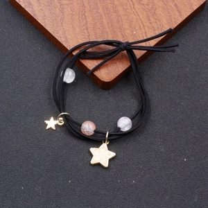 Multi-strand elastic hair tie with glitter beads and cream star charms in black color