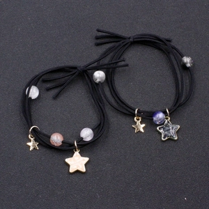Star charm hair ties in multi-layer elastic design with sparkling beads and gold accents