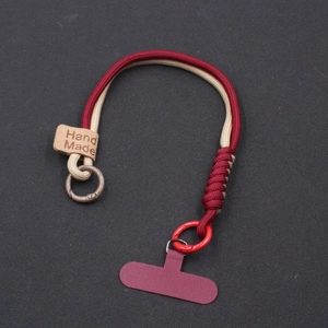 Handmade woven phone wrist strap in dark red and beige with metal carabiner and leather tag