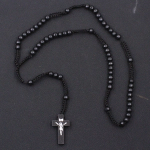 Detail showing hand-woven black 8mm wooden prayer beads and crucifix cross pendant necklace