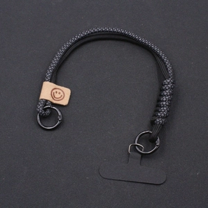 Universal woven paracord phone lanyard with leather smiley charm and metal ring