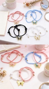 Detalle de pulseras magnéticas de mariposa con cordón trenzado e imán de corazón unido
