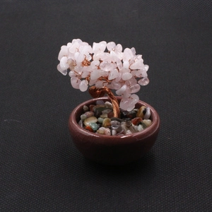 Detailed macro of pink crystal money tree with hand-twisted copper wire and ceramic pot