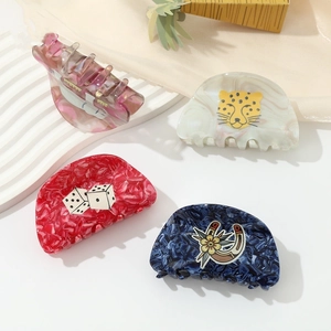 Set of four stylish acetate claw clips in marble pink, white, red, and blue animal motifs