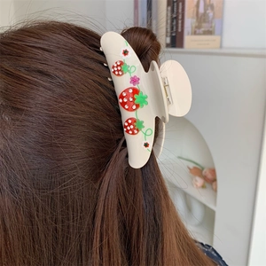 Elegant large cream hair claw clip with crystal strawberries on dark brown hair