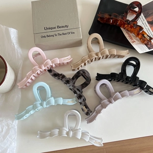 Large jelly-colored bow hair claws in 8 colors including pink, blue, and tortoiseshell