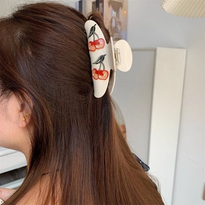 Elegant cream cherry hair claw clip with rhinestones worn on long brown hair