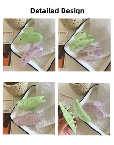 Detail view of acetate shark hair clips with rhinestone floral patterns in two colors
