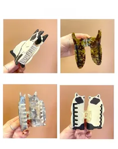 Detailed view of cat-shaped acetate hair claws with premium texture and metal springs