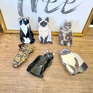 Chic cat shaped acetate hair claws in various patterns on a wooden surface