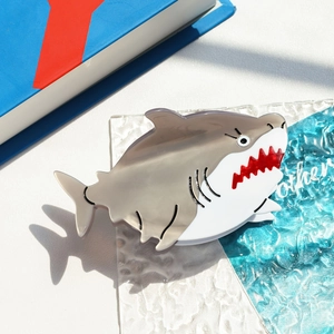 Detail view of acetate shark hair claw clip with grey white finish and creative design
