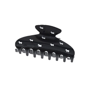 Black acetate hair claw clip featuring white Scottish Terrier dog patterns and glossy finish