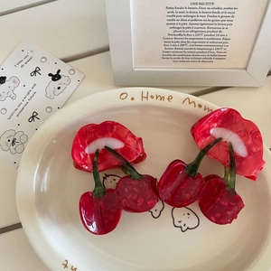 Red lip and cherry acetate hair claw clips set for women in a stylish ceramic plate