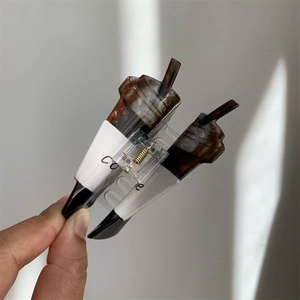 Detail view of coffee cup shaped acrylic hair claw clip with coffee lettering