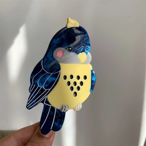 Cute cockatiel-shaped hair claw clip made of blue and yellow marbled acetate material