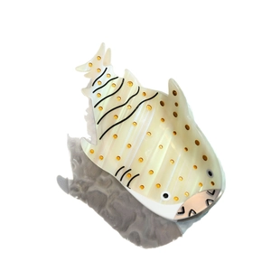 Elegant whale shark shaped hair claw clip in pearlescent white with orange wave patterns