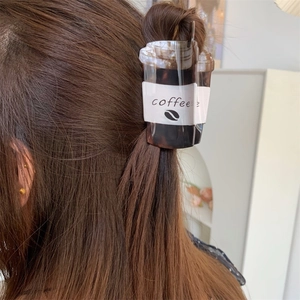 Creative coffee cup shaped hair claw clip in dark brown acrylic for a unique half-up hairstyle