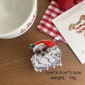 Vue détaillée de la pince à cheveux Père Noël avec dimensions sur un fond festif