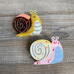 Colorful acetate hair claws in snail shape with marble texture and polished finish