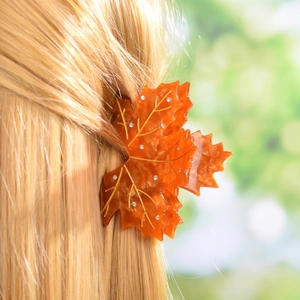 Elegant amber maple leaf hair claw clip with rhinestones shown on blonde hair