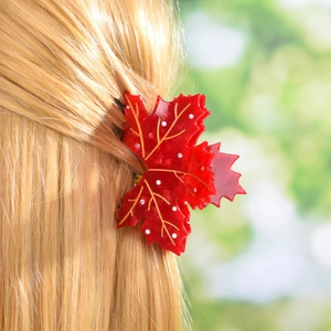 Elegant red maple leaf acetate hair claw with rhinestones on blonde wavy hair