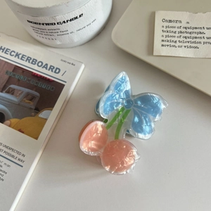 Detail of cherry hair claw clip in ice blue and peach pink with pearlescent texture