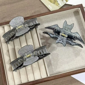 Detail view of Halloween hair claw clips set with bat design and silver glitter finish