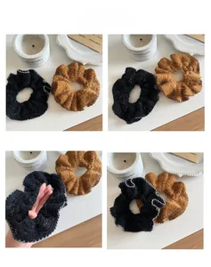 Detailed views of fuzzy knit scrunchies in black and brown with elastic stretch detail