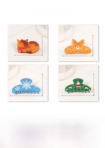 Detail view showing four Christmas claw clips with cat, reindeer and snowflake patterns