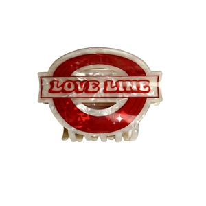 Pearlescent white acetate hair claw with red Love Line logo in London tube style