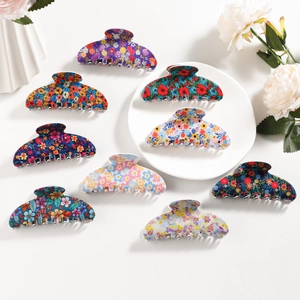 Set of 8 floral pattern hair claws with vintage daisy designs on a clean white backdrop