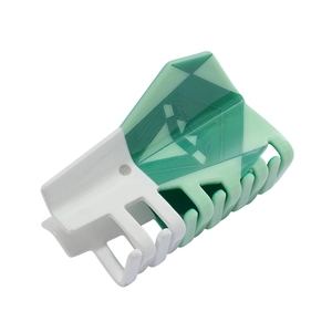 Close-up of a green and white checkered acetate hair claw clip with geometric patterns