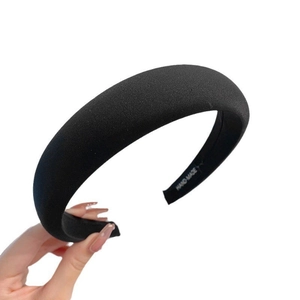 Classic black padded sponge headband with premium satin texture for high-volume hair look
