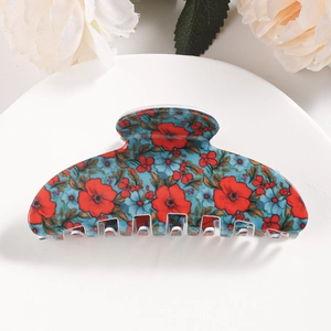 Detailed view of a vintage floral hair claw clip with red and blue flower patterns
