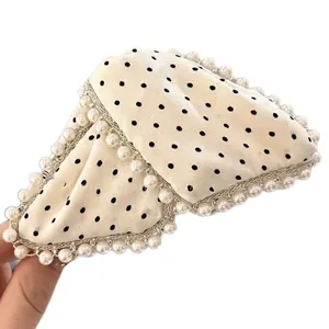 Elegant French pearl hair claw clip with black polka dots on cream fabric bow