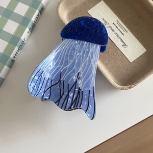 Detailed macro view of creative blue jellyfish hair claw made of premium acrylic acetate