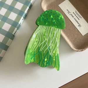 Detail shot of the jellyfish hair claw clip made of green translucent acetate