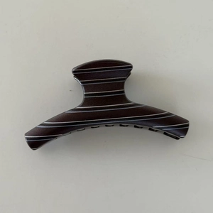 Brown striped minimalist hair claw clip with wood grain finish for elegant updos