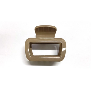 Detail of a rectangular hollow hair claw clip in khaki with a glossy smooth finish