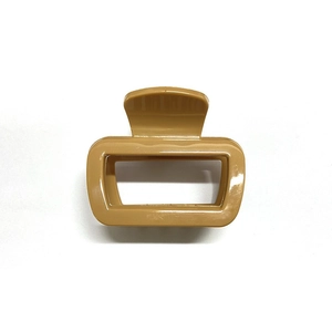 Close-up of matte khaki square hollow hair claw clip made of soft silicone material