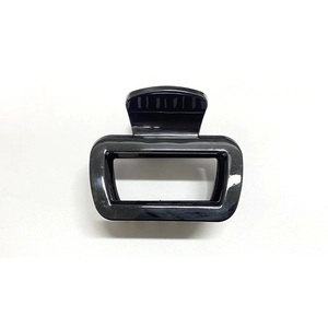Detail view of a black square cutout hair claw clip made of durable soft silicone material