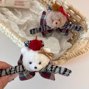 Cute plush bear hair claw clip with festive red and green plaid ribbon bows for women