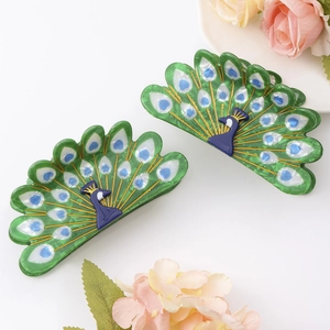 Elegant peacock hair claw clips in green and blue acetate with artistic gold feather details