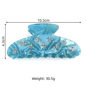 Blue marble acetic acid hair claw clip with cross rhinestones and dimensions 10.5cm by 4.3cm