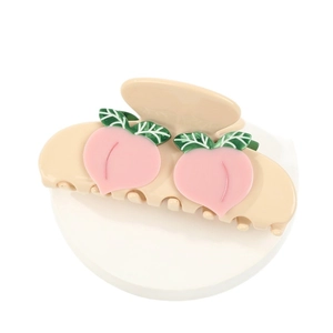 Elegant cream peach claw clip for women featuring sweet pink fruit and green leaf accents